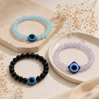 Evil Eye Combo Bracelet set featuring three soft-toned beaded bracelets in violet, sky blue, and black, each with an Evil Eye centerpiece.