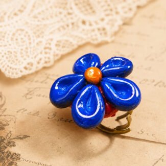Handmade clay Royal Blue Petal Ring with five deep blue petals and a warm orange centre.