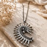 Oxidised silver Tribal Sun Spiral Pendant with an intricate spiral design and radiating teardrop-shaped details.