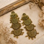 Antique oxidised gold-tone chandelier earrings with intricate floral motifs, layered filigree work, and dangling bead details.