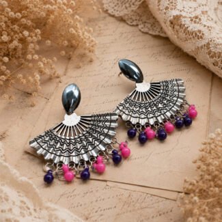 Timeless oxidised silver fan-shaped earrings with intricate geometric detailing and pink and purple bead accents.