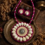 Handmade Cowrie Mandala Necklace Set with real cowrie shells, natural jute, oxidised metal pendant, pink plastic beads, light pink crystal beads, and matching earrings.