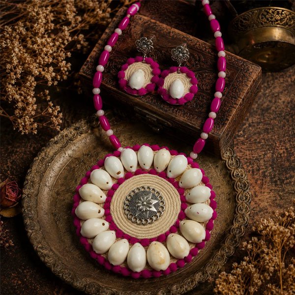 Handmade Cowrie Mandala Necklace Set with real cowrie shells, natural jute, oxidised metal pendant, pink plastic beads, light pink crystal beads, and matching earrings.