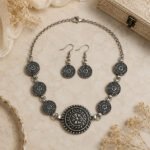 Srida Mandala Grace Choker Set featuring an oxidized silver finish with intricate mandala motifs, matching fish hook earrings, extension chain, and secure lobster clasp.