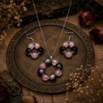 Handmade Pink Twilight Beaded Pendant Set with matching earrings, featuring blush pink crackle glass beads, glossy black beads, and a silver-tone chain in a vintage-inspired design.