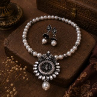 Silver Bloom Pearl Necklace Set featuring an oxidized silver floral pendant with white pearl beads and matching pearl drop earrings.
