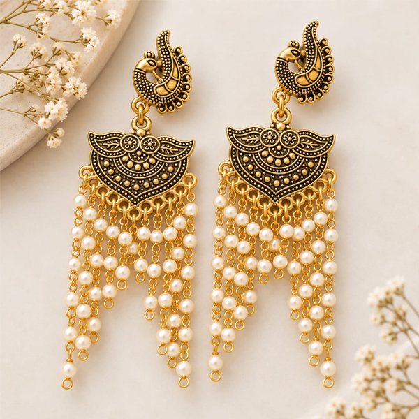 Srida antique oxidised gold pearl drop earrings with ornate peacock-inspired detailing and cascading white pearl beads.