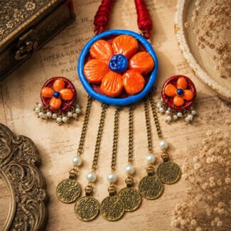 Handcrafted Antique Bloom Clay Coin Necklace set with glossy floral clay pendant, matching earrings, antique coin charms, golden chain, and pearl accents on a vintage background.