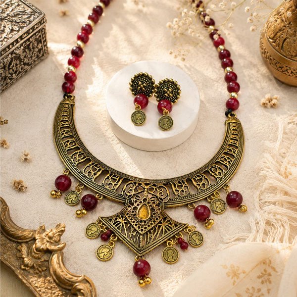 Antique Crescent Charm Necklace Set with maroon beads, vintage coin charms, and matching earrings handcrafted in an oxidised gold-tone finish.