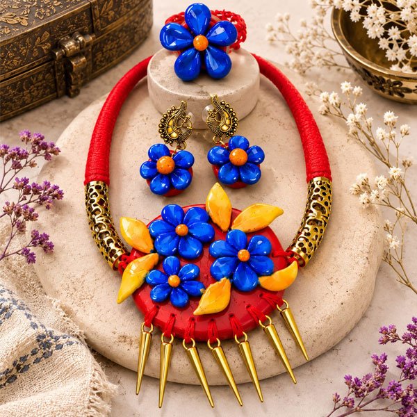 Handmade Blue Bloom Clay Necklace Set featuring glossy blue floral clay pendant, oxidised metal accents, matching earrings, and an adjustable finger ring.