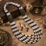 Classic Maroon Ivory beaded necklace set with matching earrings, featuring layered white and maroon beads with antique dragon-pattern metal panels.