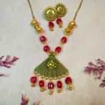 Elegant red and golden oxidised Ganesha pendant necklace with vibrant red beads, minimal festive jewelry for celebrations.