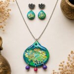 Handmade Peacock Feathers clay pendant set with blue, green, and golden peacock-inspired details, matching earrings, clay beads, and silver chain.