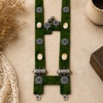 Handcrafted green batik fabric statement necklace set with oxidized silver accents, navi sankha beads, and matching earrings in a vintage antique style.